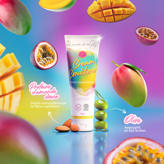 Cream conditioner tube with almonds, olives, mango, and passion fruit on a colorful background, natural hair care.