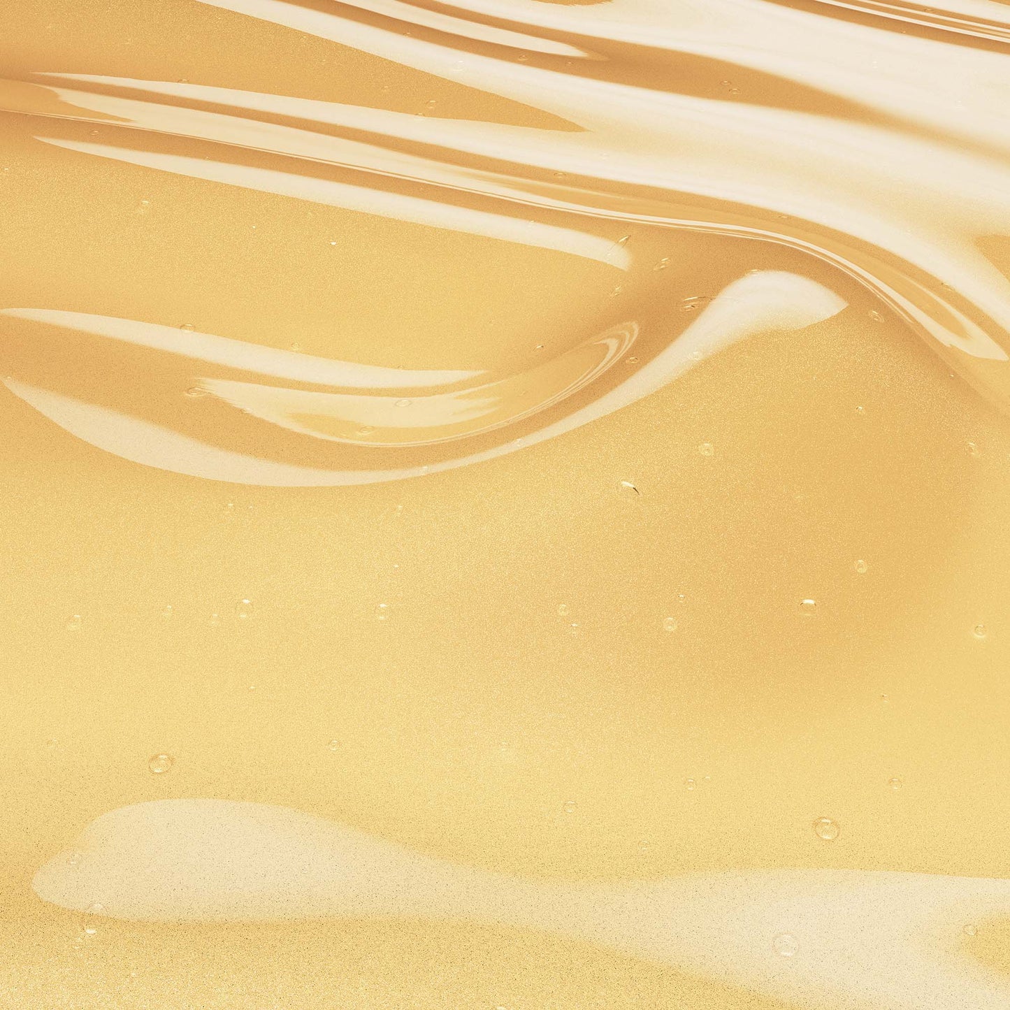 Golden honey hair serum texture with smooth, wavy surface and glossy finish