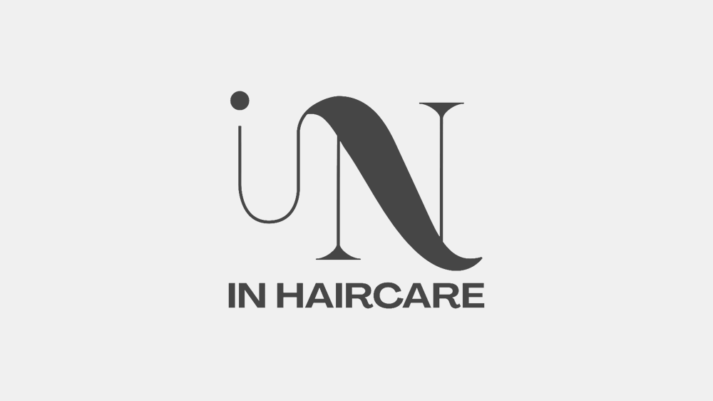 Modern IN HAIRCARE logo in black text on a light background, haircare branding design