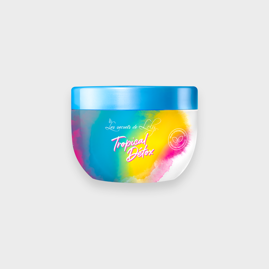 Colorful jar of Tropical Detox hair care treatment with blue lid, vibrant label on white background
